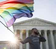 Same-sex marriage supporter Vin Testa, of Washington DC, waves a rainbow pride flag near the Supreme Court