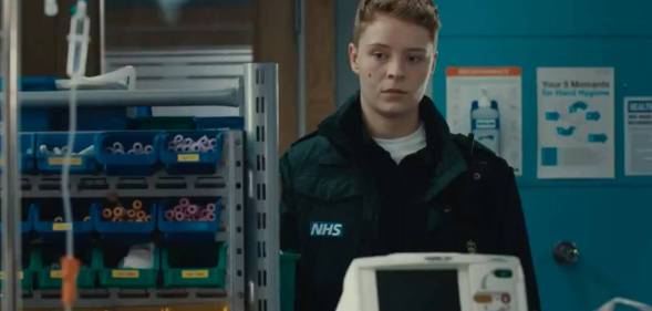 A still from Casualty showing Sah, a new recruit to the paramedic team. Sah is Casualty's first trans recurring character, and they are played by Arin Smethurst.