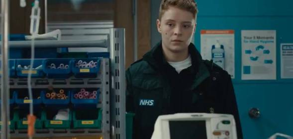 A still from Casualty showing Sah, a new recruit to the paramedic team. Sah is Casualty's first trans recurring character, and they are played by Arin Smethurst.