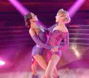 A still image of JoJo Siwa and Jenna Johnson from Dancing With the Stars where they dance amid pink and blue lighting