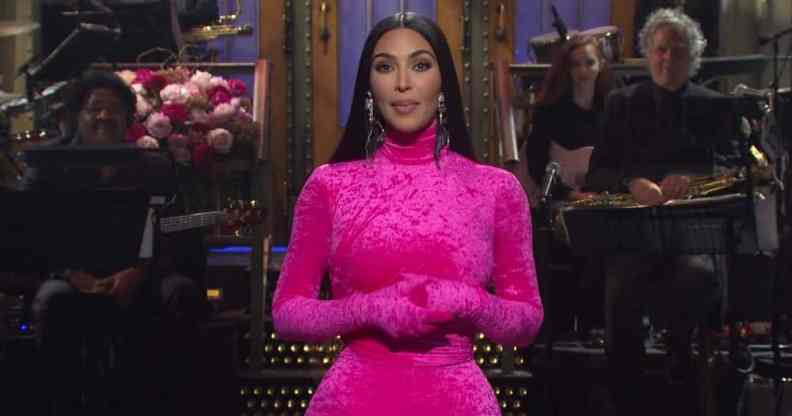 Kim Kardashian is dressed in a hot pink bodysuit onstage as host of Saturday Night Live