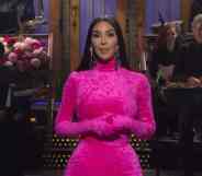 Kim Kardashian is dressed in a hot pink bodysuit onstage as host of Saturday Night Live