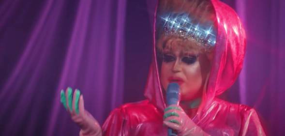 a drag queen performs in a pink outfit on the Russia drag series 'Royal Cobras'