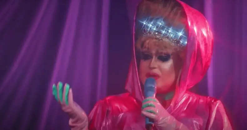 a drag queen performs in a pink outfit on the Russia drag series 'Royal Cobras'