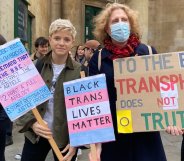 Mae Martin holds placards at the protest outside Broadcasting House
