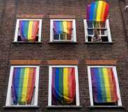 Rainbow flags cover a set of windows in Soho at Pride in London in 2019.