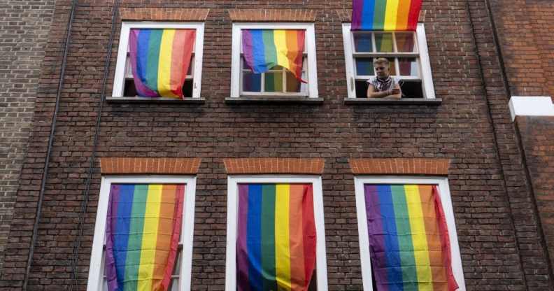 Rainbow flags cover a set of windows in Soho at Pride in London in 2019.
