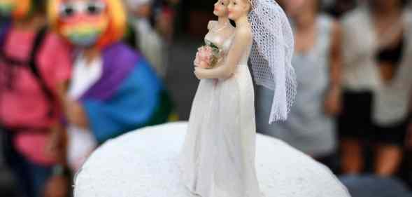 Two female cake-toppers on wedding cake