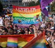 Demonstrators mark with LGBT+ Pride flags during a Pride parade in Budapest, Hungary