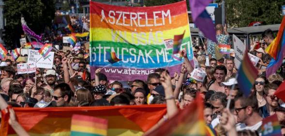 Demonstrators mark with LGBT+ Pride flags during a Pride parade in Budapest, Hungary