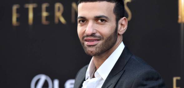 Haaz Sleiman appears in a black suit jacket and white shirt at a premiere of Marvel's Eternals