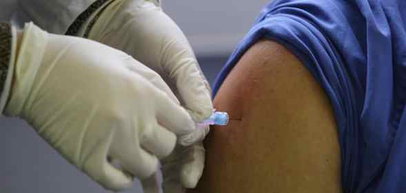 A needle is inserted into a person's arm