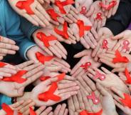 University students in China display red ribbons to mark World AIDS day
