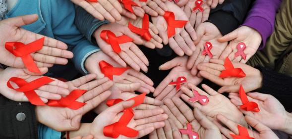 University students in China display red ribbons to mark World AIDS day