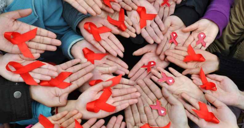 University students display red ribbons during an event to promote the awareness of AIDS at the Sichuan University on World AIDS Day 2009.