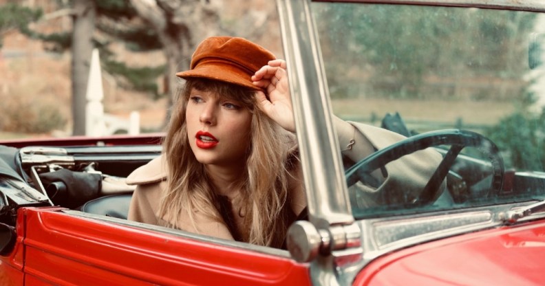 Taylor Swift sitting in a car in a promotional image for Red (Taylor's Version)
