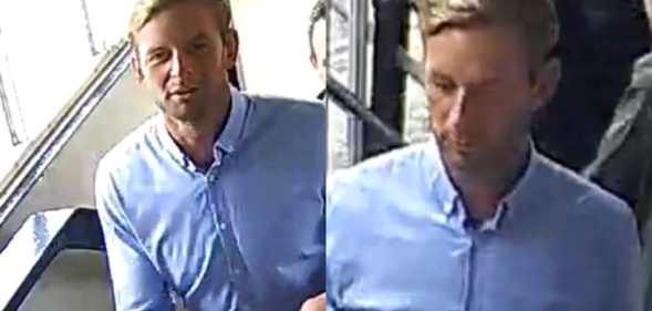 A man in a blue dress shirt and grey trousers