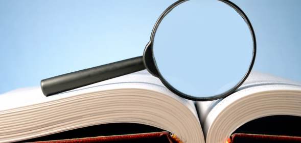 A picture of a magnifying glass on top of a dictionary