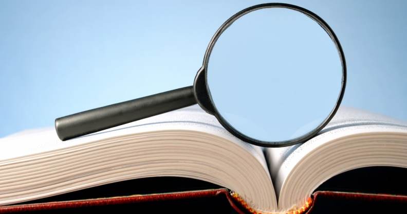 A picture of a magnifying glass on top of a dictionary
