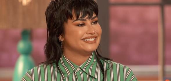 Demi Lovato in a green striped shirt