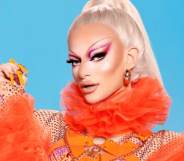 Krystal Versace poses in an orange outfit against a blue background