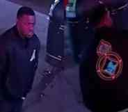 CCTV footage of a man in a black graphic jacket involved in a homophobic attack