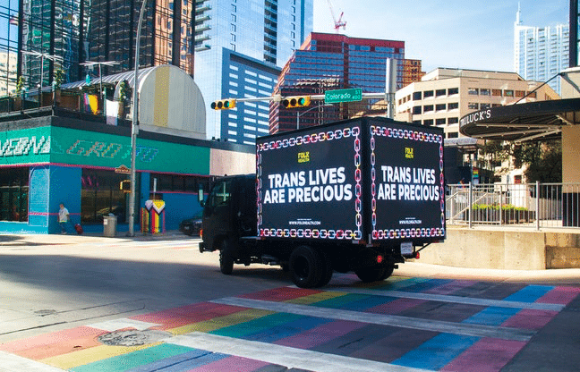 Billboard reading "trans lives are precious" in Texas