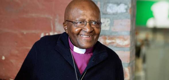 Archbishop Emeritus and Nobel Laureate Desmond Tutu smiles at the camera while attending an exhibition in Cape Town in 2019