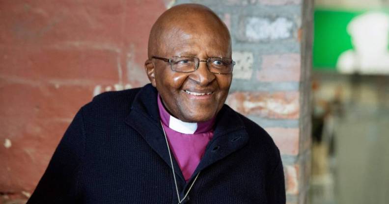 Archbishop Emeritus and Nobel Laureate Desmond Tutu smiles at the camera while attending an exhibition in Cape Town in 2019