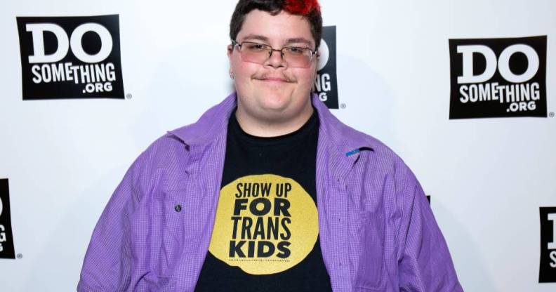 Gavin Grimm attends the 2019 DoSomething Gala in a black shirt with the words 'show up for trans kids' and a purple button up shirt