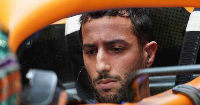 Daniel Ricciardo looking down in his motorcar