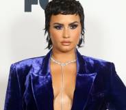 Demi Lovato appears in a blue-purple velvet outfit at the iHeartRadio Music Awards in May 2021