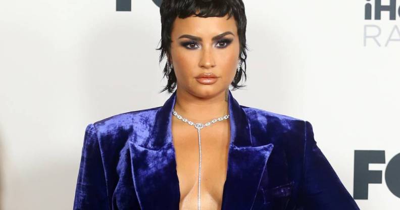 Demi Lovato appears in a blue-purple velvet outfit at the iHeartRadio Music Awards in May 2021