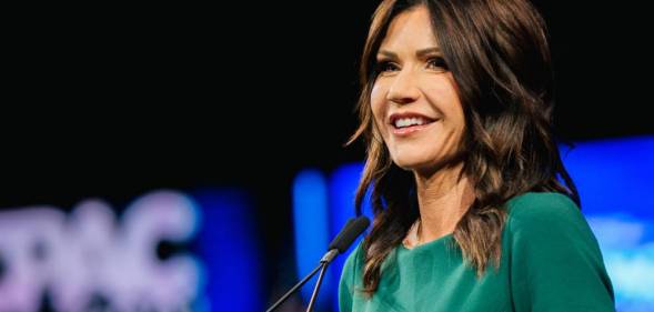 South Dakota governor Kristi Noem wears a gree outfit during her speech at the Conservative Political Action Conference on 11 July 2021