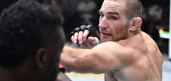 Sean Strickland punches Uriah Hall of Jamaica