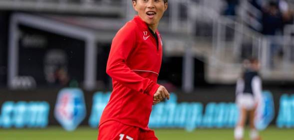 Kumi Yokoyama appears in a red Washington Spirit uniform while warming up for a match against the Houston Dash