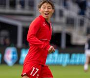 Kumi Yokoyama appears in a red Washington Spirit uniform while warming up for a match against the Houston Dash