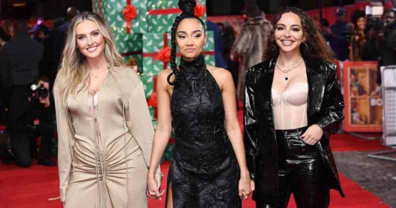 Little Mix stars Perrie Edwards, Leigh-Anne Pinnock and Jade Thirlwall hold hands on the red carpet at Boxing Day film premiere
