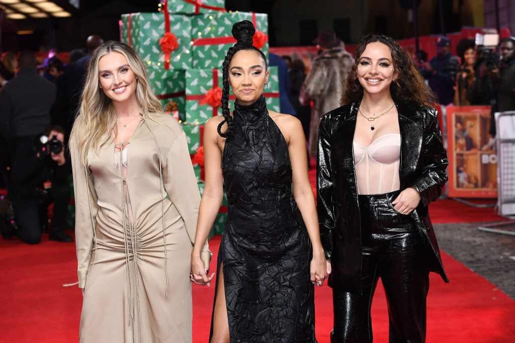Little Mix stars Perrie Edwards, Leigh-Anne Pinnock and Jade Thirlwall hold hands on the red carpet at Boxing Day film premiere