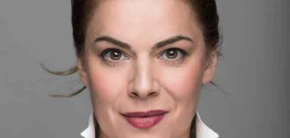 Headshot of Rosie Kay against a grey background