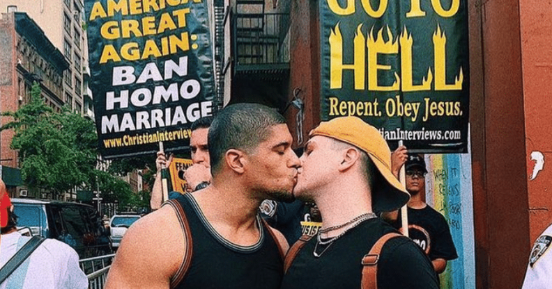 Anthony Bowens kisses boyfriend in front of crowd of homophobic protesters