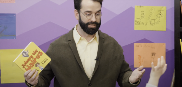 Matt Walsh poses with his anti-trans children's book titled Johnny the Walrus.
