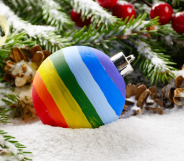 A rainbow bauble on a bed of snow