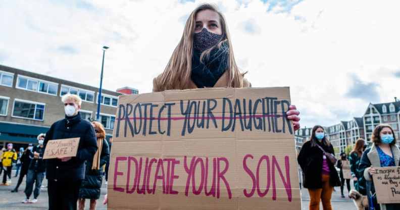 A woman holding a sign with 'protect your daughters' crossed out, and 'educate your son' written underneath