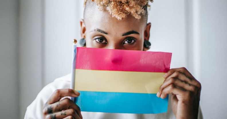 A person holds a pansexual pride flag