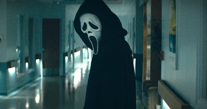 Ghostface in Scream standing in a corridor
