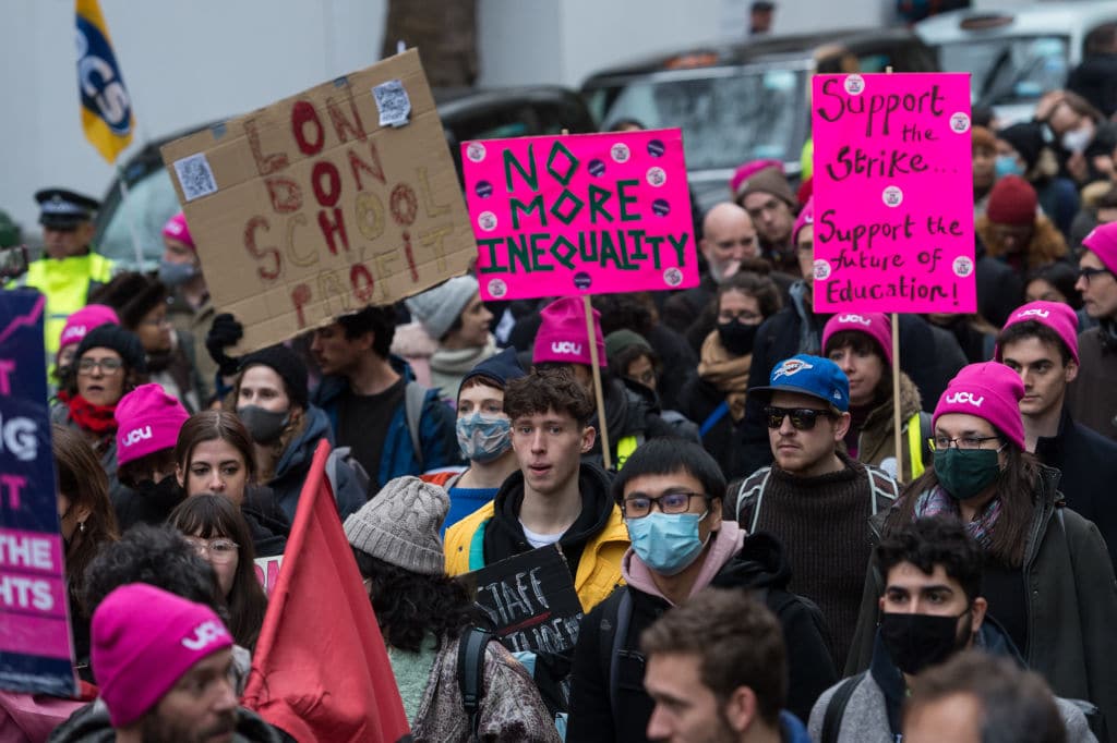 Students marching with placards reading things like 'no more inequality'