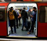 Commuters wearing PPE, including a face mask, while on travelling on the morning rush hour on the TfL