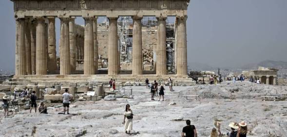 Tourists are seen outside the Ancient Acropolis archeological site in Athens Greece