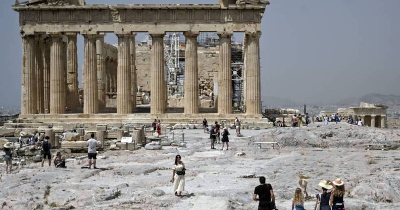 Tourists are seen outside the Ancient Acropolis archeological site in Athens Greece